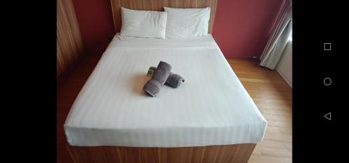 a pair of socks sitting on a bed at Vortex suites klcc by yana in Kuala Lumpur