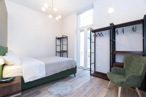 a bedroom with a bed and a chair at Sweet home in Turin