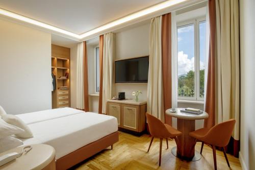 a hotel room with a bed and a window at Villa Miliani in Fabriano