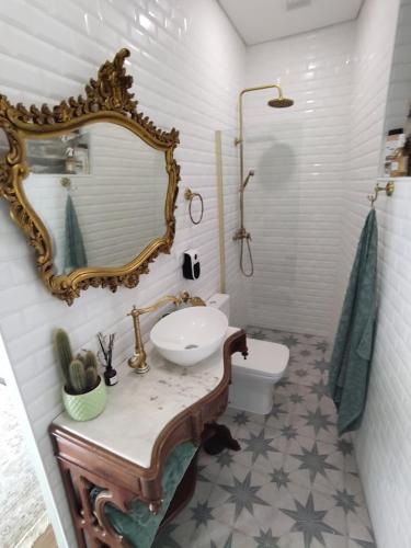 a bathroom with a sink and a mirror on the wall at Refúgio no Douro in Nogueira