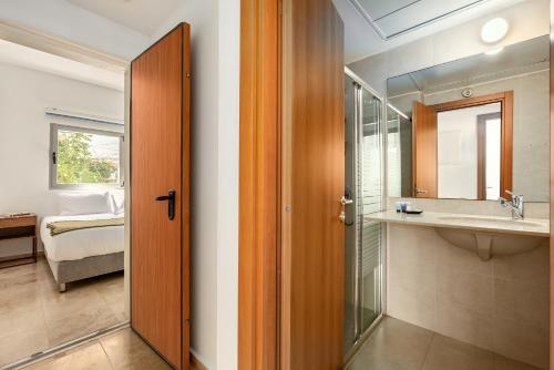 a bathroom with a sink and a mirror at Gordon Beach Bright Spacious Stay in Tel Aviv