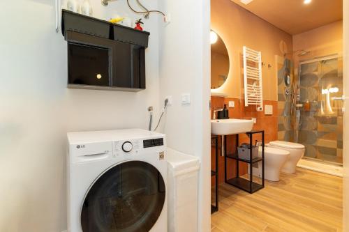 a washing machine in a bathroom with a sink at Sweet home in Turin