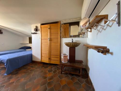 a bedroom with a bed and a table and a mirror at Maison proche de la mer in Sainte-Marie-la-Mer