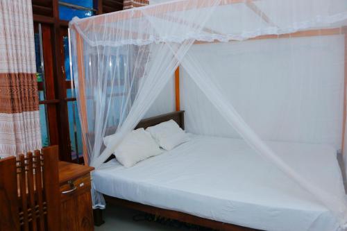 Ένα ή περισσότερα κρεβάτια σε δωμάτιο στο Nature Paradise Midigama