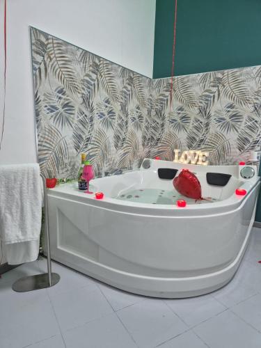 a white bath tub in a bathroom with a wall at House Mari in Catania