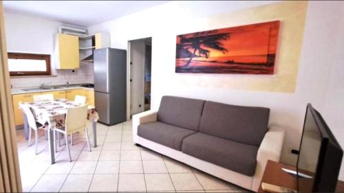 a living room with a couch and a kitchen with a table at Eli's House in Bardolino sul Garda in Bardolino