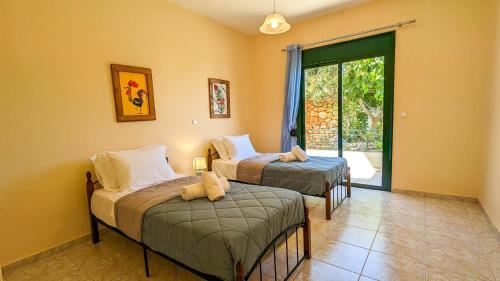 Postel nebo postele na pokoji v ubytování Villa Iris