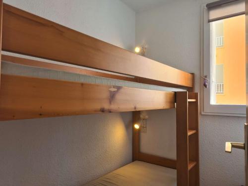 a bunk bed in a room with a window at T2 cabine - CAP D'AGDE CT300-124 in Cap d'Agde