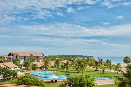 an aerial view of the resort with the ocean in the background at The Calm Resort & Spa in Pasikuda