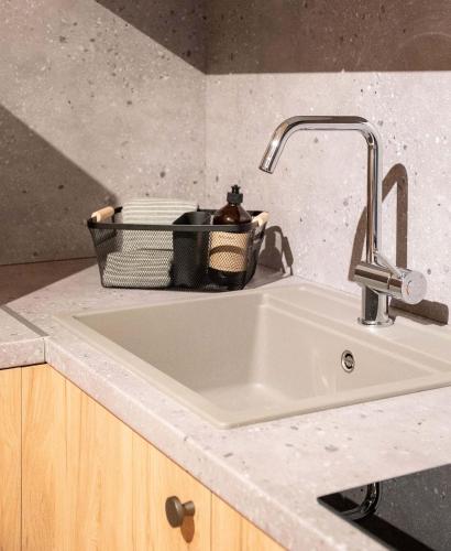 a kitchen sink with a basket on top of it at City Core Plataia Agora in Katerini