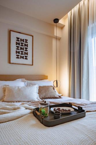 a tray of food on a bed in a bedroom at City Core Plataia Agora in Katerini
