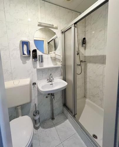 a bathroom with a toilet and a sink and a shower at CoronaZeist-Utrecht NL in Zeist