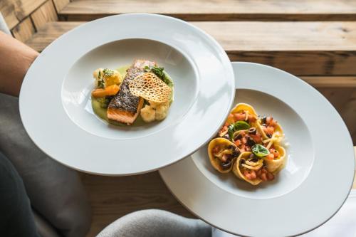 two white plates of food on a table at Lodge Brocco & Posta in San Bernardino