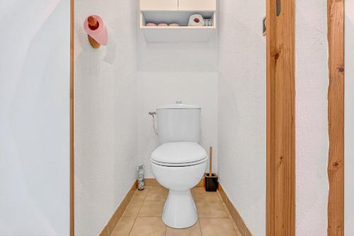 a bathroom with a white toilet in a room at Appart Tallas Pieds Des Pistes in Ancelle