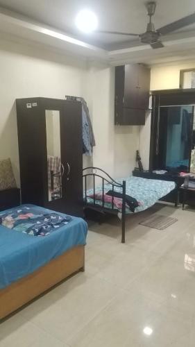 a room with two beds and a mirror in it at Lakeside in Mumbai