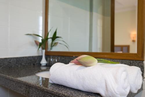 a towel on a bathroom counter in front of a mirror at Grand Bayon Siem Reap Hotel in Siem Reap