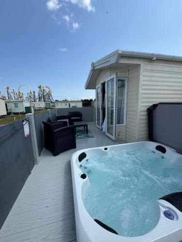 a hot tub on the deck of a house at Fantasy Island - Eastgate E6 - The Sierra with Hot Tub - Coastal Caravan Breaks in Ingoldmells