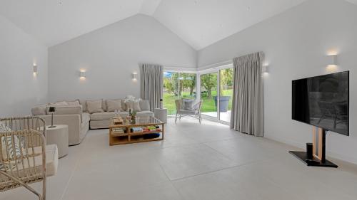 a living room with a couch and a tv at Lambs Lawn in Coulston