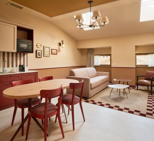 a living room with a table and chairs and a couch at Homy Livia Verona in Verona