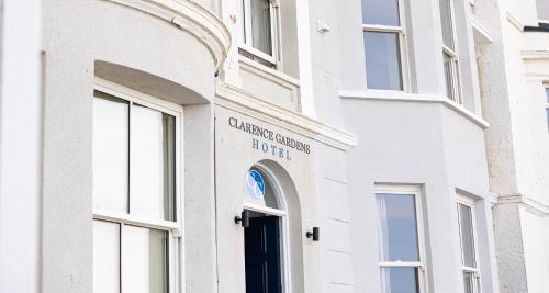 a white building with a sign on the door at The Clarence Gardens Hotel, BW Signature Collection in Scarborough