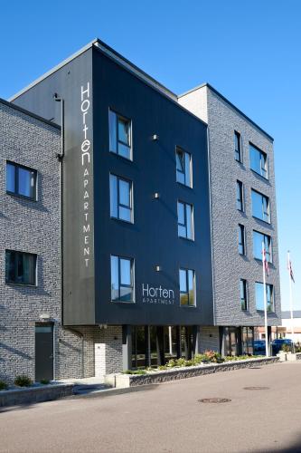 a building with a sign on the side of it at Horten Apartment in Horten