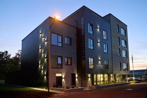 a black building with a street light in front of it at Horten Apartment in Horten