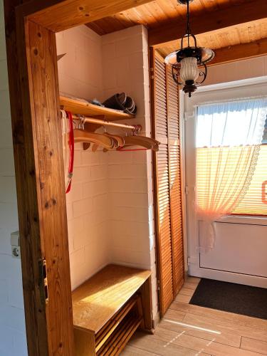 a room with a closet with a wooden door at Rehblick RE11 in Sögel