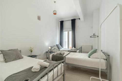 a bedroom with two beds and a window at Estrela House by Homing in Lisbon