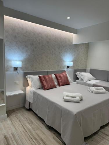 a bedroom with a large bed with towels on it at Ines Apartments in Giardini Naxos