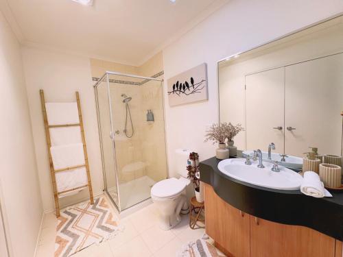 a bathroom with a sink and a toilet and a shower at Bentleigh Private 1BR 5min Train Cafes Quiet Cozy in Melbourne