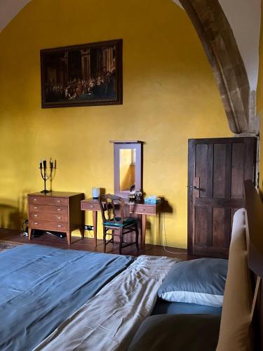 a bedroom with a bed and a table and a desk at Chateau d Albon - Catherine de Medicis in Saint-André-dʼApchon