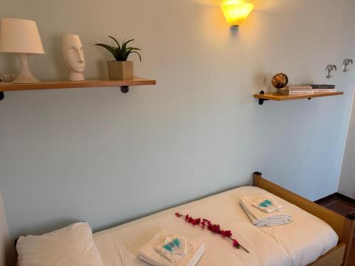 a bedroom with a bed with red flowers on it at Grigna Roberta s Lodge - Wi-Fi Gratuito in Civenna