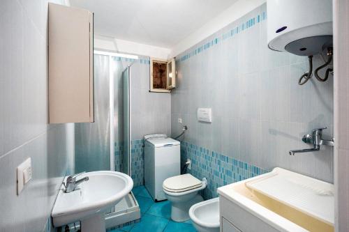 a bathroom with a white toilet and a sink at Ce Tour - Casa Cetara Centro in Cetara