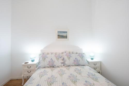 a bedroom with a bed and two night stands at Alfarrobeira House in Cascais