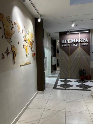 a hallway with a map of the world on a wall at Prestige Ap in Ustʼ-Kamenogorsk