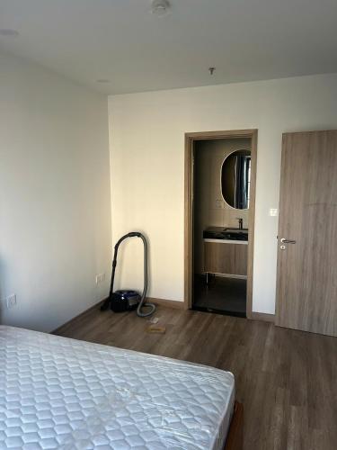 an empty room with a bed and a bathroom at H-Vista Suites - The Wisteria 