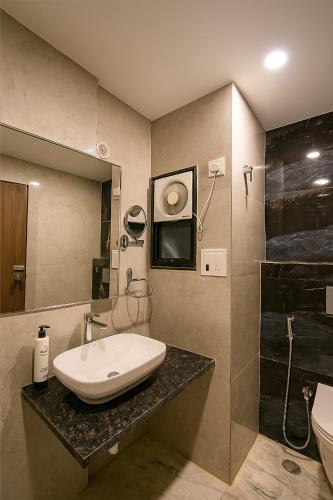 a bathroom with a sink and a shower at The EcoXpress Satva Varanasi - Vegetarian with all Options in Varanasi
