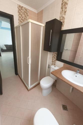 a bathroom with a toilet and a sink at Sea Breeze Apartment Sharm el-Sheikh in Sharm El Sheikh