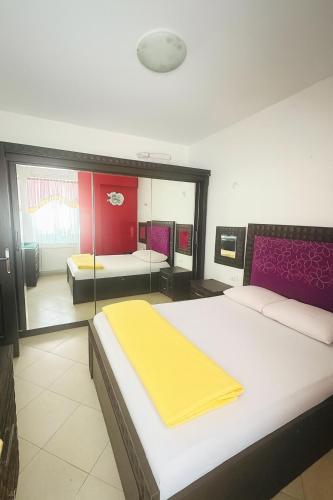 a bedroom with two beds and a mirror at Sea Breeze Apartment Sharm el-Sheikh in Sharm El Sheikh