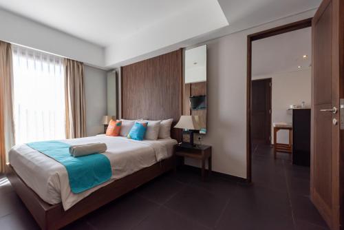 Postel nebo postele na pokoji v ubytování Sans Vibes Hotel Seminyak
