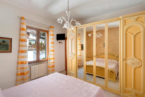 a bedroom with a bed and a chandelier at Ce Tour - Nonni's Lemon House in Cetara