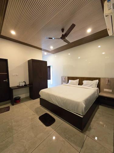 a bedroom with a bed with a ceiling fan at SDK RESIDENCY in Shravanabelagola