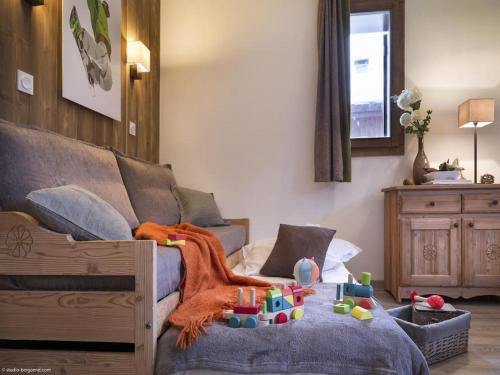 a room with a couch and a table with toys on it at Charmant studio centre Val d'Isère - Balcon vue montagne - in Val dʼIsère
