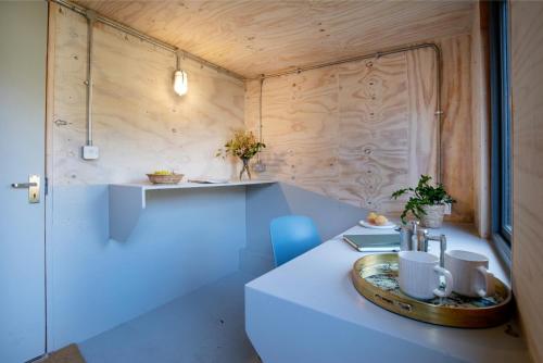 a small kitchen with a table with a tray on it at Dragonfly Cottage in Topsham