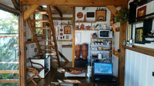 a kitchen with a refrigerator and a laptop on a table at Maia House Hostal in Florianópolis