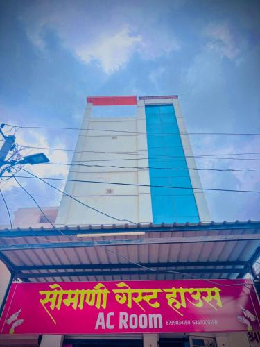 een hoog gebouw met een bord ervoor bij Somani guest house in Bāsni