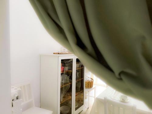 a room with a white cabinet with a curtain at Eldoh in Bernalda