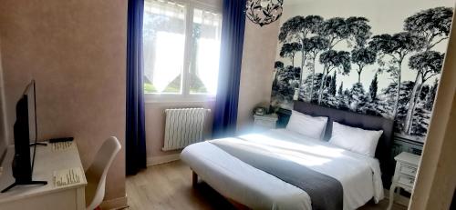 a bedroom with a bed and a window with trees on the wall at Hotel du Commerce Chez Stéphane in Roumazières