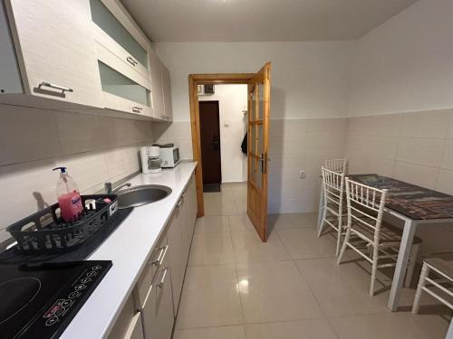 a kitchen with a sink and a counter at Aparthotel Brasov Neptun in Braşov
