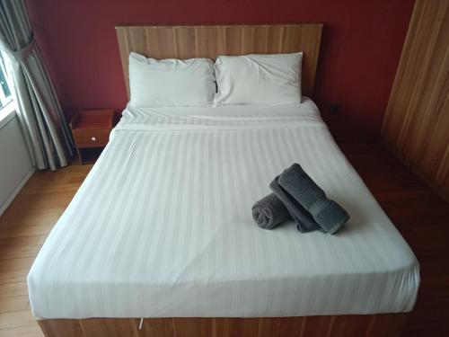a large white bed with two towels on it at Vortex suites klcc by yana in Kuala Lumpur